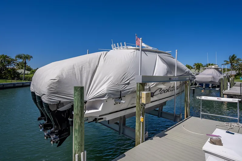  Yacht Photos Pics Covered 2010 Intrepid 370 Open boat on lift at marina dock.