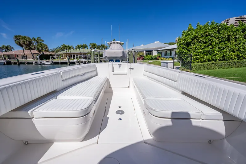  Yacht Photos Pics 2010 Intrepid 370 Open boat interior with white seating, docked near waterfront homes.