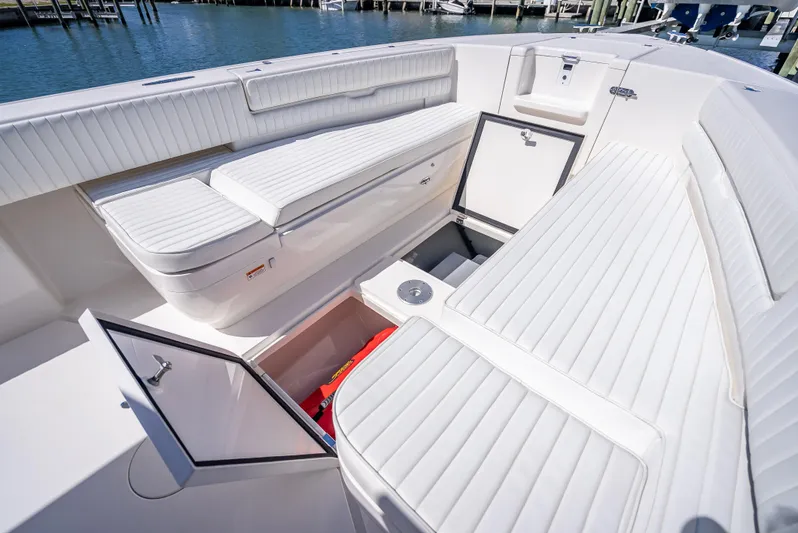  Yacht Photos Pics 2010 Intrepid 370 Open boat interior with white cushioned seating and storage compartments.
