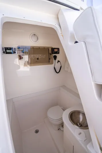  Yacht Photos Pics 2010 Intrepid 370 Open boat interior with compact bathroom and sink.