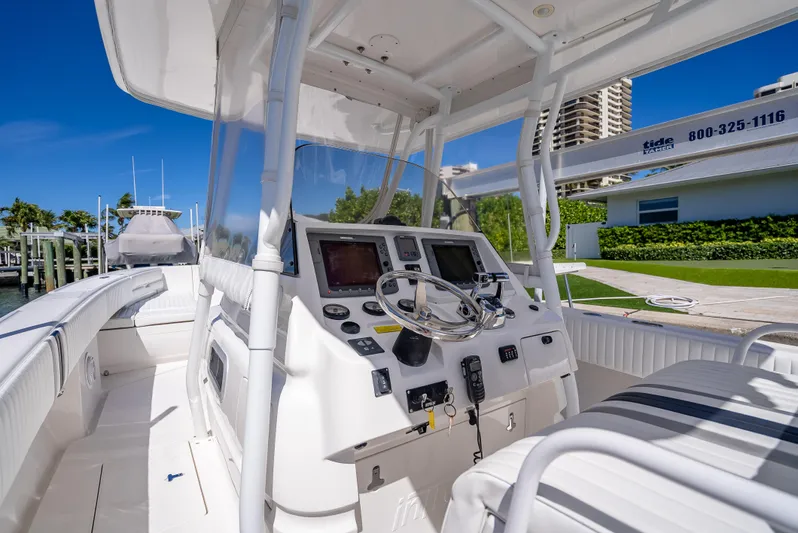  Yacht Photos Pics 2010 Intrepid 370 Open boat cockpit with steering wheel and navigation equipment.
