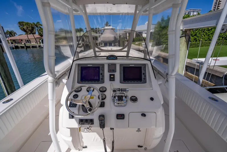  Yacht Photos Pics 2010 Intrepid 370 Open boat cockpit with steering wheel and navigation screens.