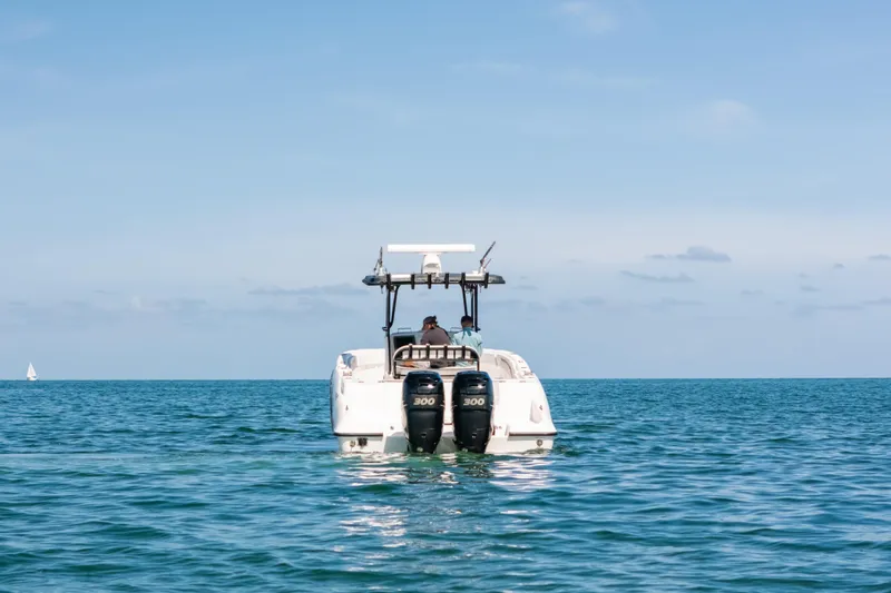  Yacht Photos Pics Deep Impact 33 boat from 2013 on open sea, clear sky, rear view.