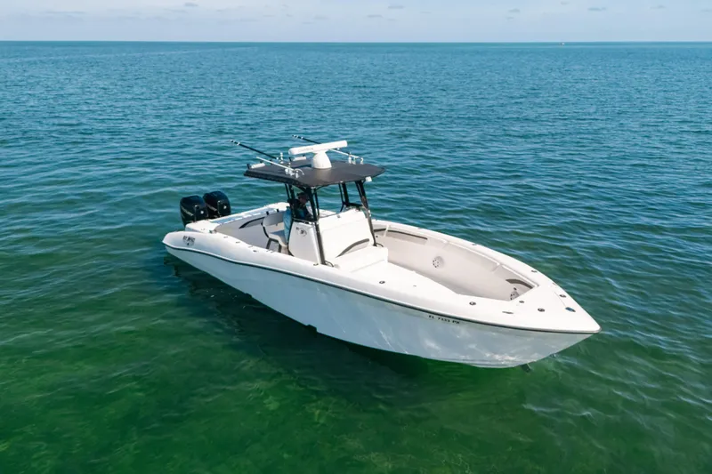  Yacht Photos Pics 2013 Deep Impact 33 boat on calm ocean waters, featuring dual engines and sleek design.