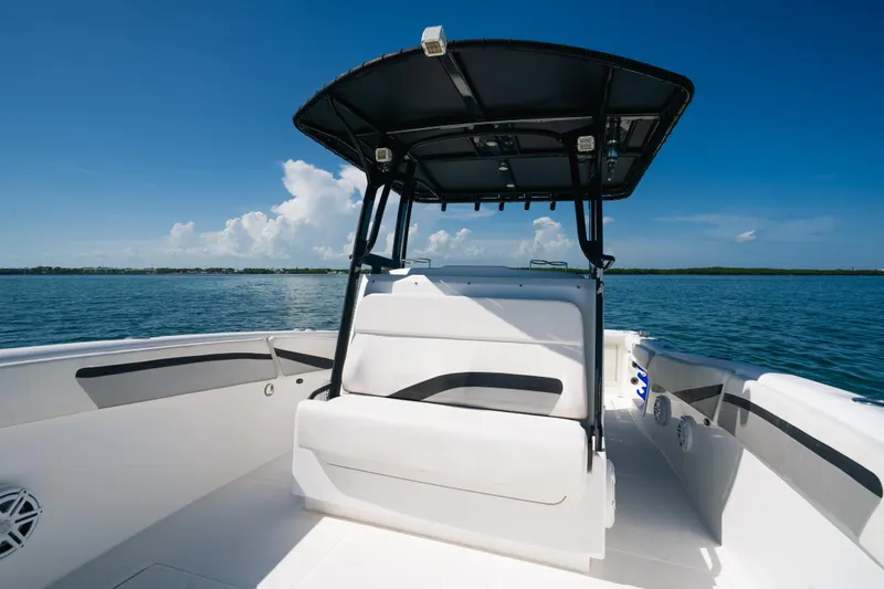  Yacht Photos Pics 2013 Deep Impact 33 boat interior with seating, under a clear blue sky on calm waters.
