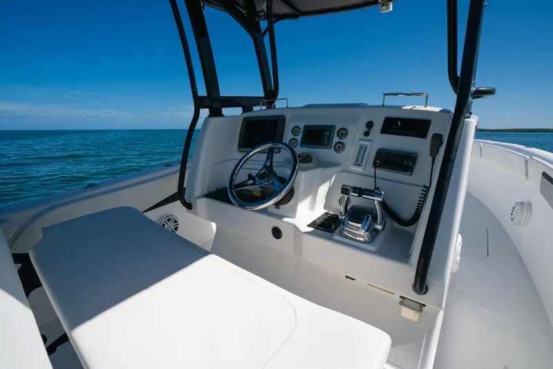  Yacht Photos Pics Cockpit of 2013 Deep Impact 33 boat with steering wheel and controls, on open water.