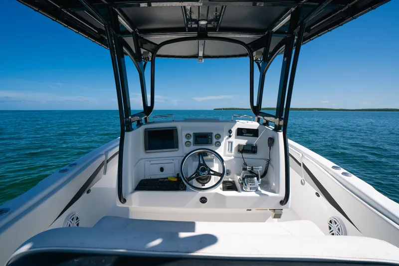  Yacht Photos Pics Cockpit view of 2013 Deep Impact 33 boat on open water under clear blue sky.