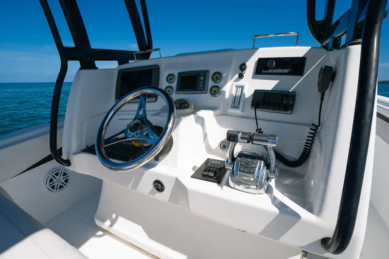  Yacht Photos Pics Cockpit of 2013 Deep Impact 33 boat with steering wheel and control panel.
