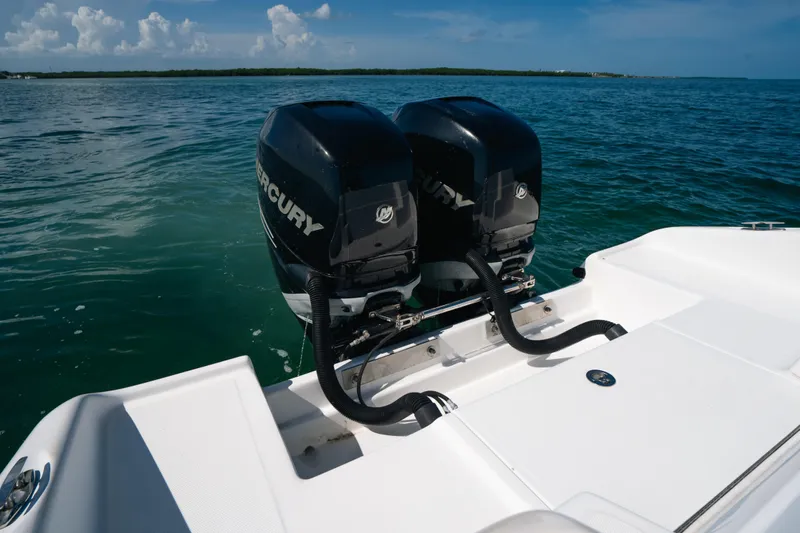  Yacht Photos Pics Twin Mercury outboard engines on a 2013 Deep Impact 33 boat, cruising on clear blue waters.