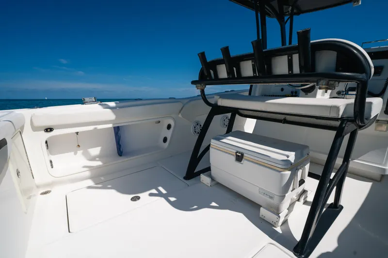  Yacht Photos Pics 2013 Deep Impact 33 boat interior with seating and cooler under clear blue sky.