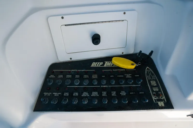  Yacht Photos Pics Control panel of a 2013 Deep Impact 33 boat with switches and key fob.