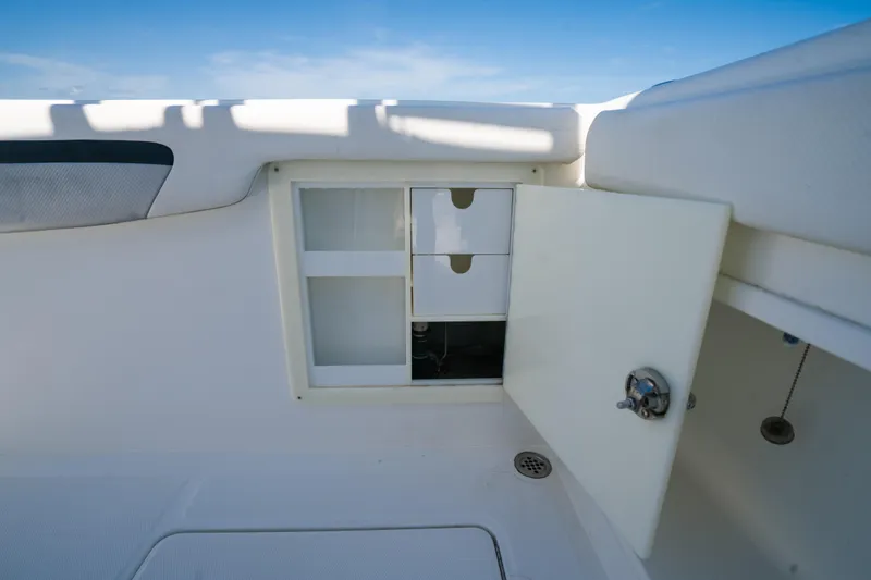  Yacht Photos Pics Open storage compartment on a 2013 Deep Impact 33 boat, featuring drawers and a latch.