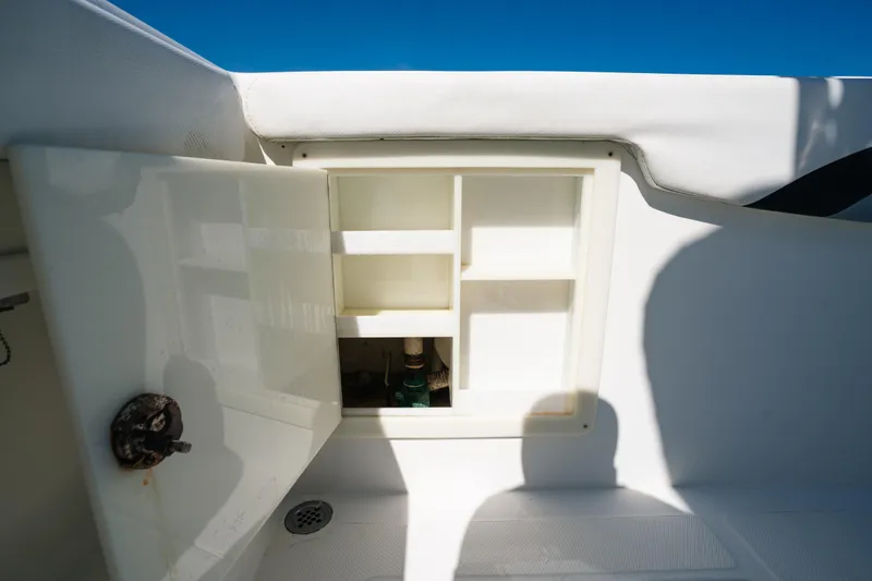  Yacht Photos Pics Open storage compartment on 2013 Deep Impact 33 boat, showcasing interior shelving.