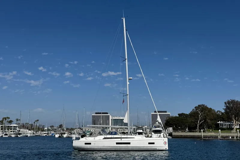 Madras Yacht Photos Pics 2022 Beneteau Oceanis 40.1 sailboat docked in a marina under clear blue skies.