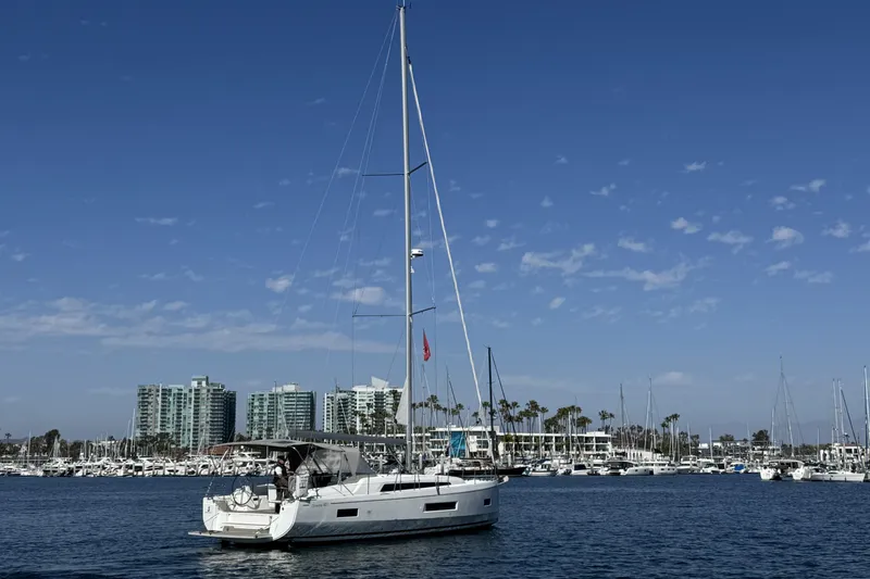 Madras Yacht Photos Pics 2022 Beneteau Oceanis 40.1 sailboat in marina with cityscape background.
