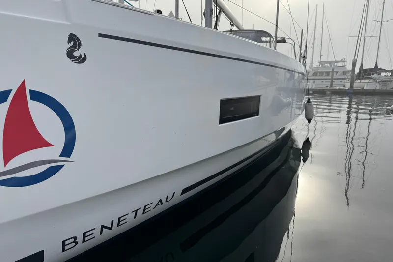 Madras Yacht Photos Pics 2022 Beneteau Oceanis 40.1 sailboat docked in a marina, reflecting on calm water.
