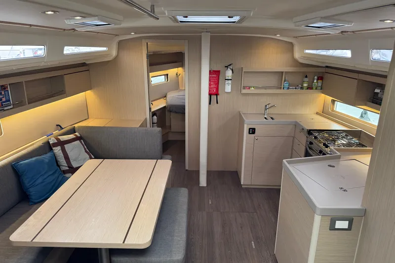 Madras Yacht Photos Pics Modern interior of 2022 Beneteau Oceanis 40.1 yacht with kitchen and seating area.