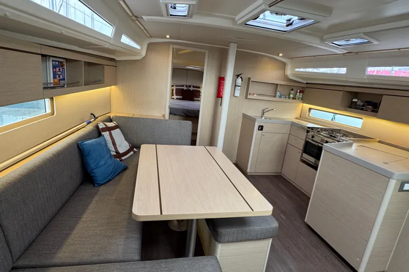 Madras Yacht Photos Pics Modern interior of 2022 Beneteau Oceanis 40.1 yacht with cozy seating and kitchen area.
