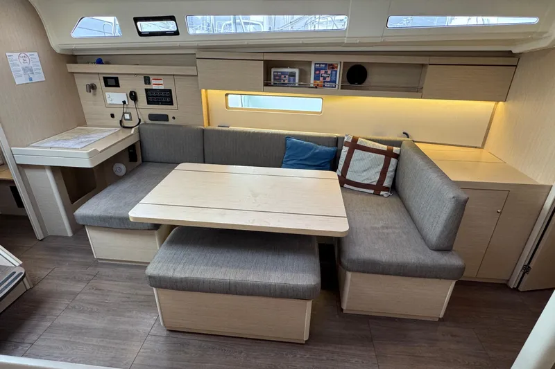 Madras Yacht Photos Pics Modern interior of 2022 Beneteau Oceanis 40.1 yacht with cozy seating and dining area.