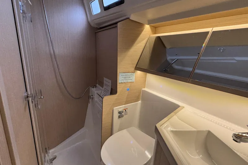 Madras Yacht Photos Pics Bathroom interior of 2022 Beneteau Oceanis 40.1 yacht, featuring modern fixtures and wood accents.