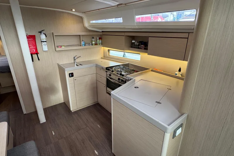 Madras Yacht Photos Pics Modern kitchen interior of 2022 Beneteau Oceanis 40.1 yacht with sleek cabinetry and appliances.