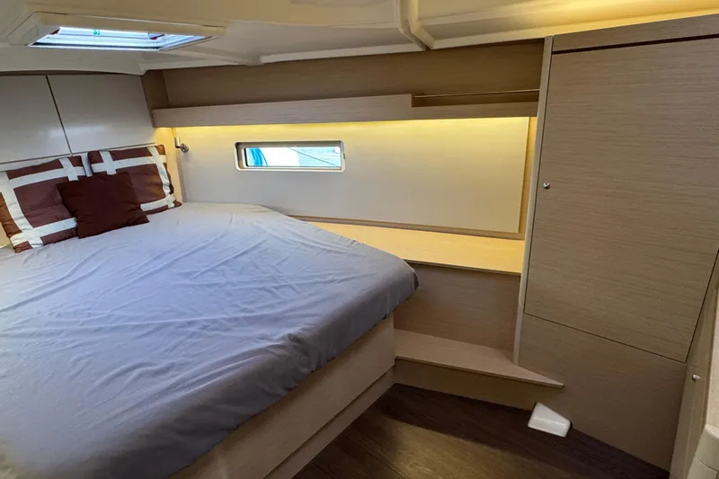 Madras Yacht Photos Pics Cozy cabin interior of 2022 Beneteau Oceanis 40.1 yacht with modern design and soft lighting.