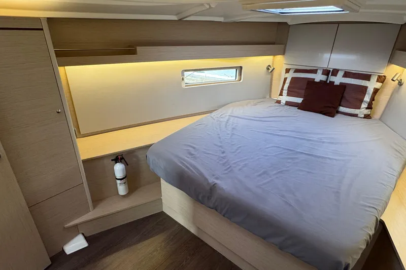 Madras Yacht Photos Pics Cozy cabin interior of 2022 Beneteau Oceanis 40.1 yacht with bed and window.
