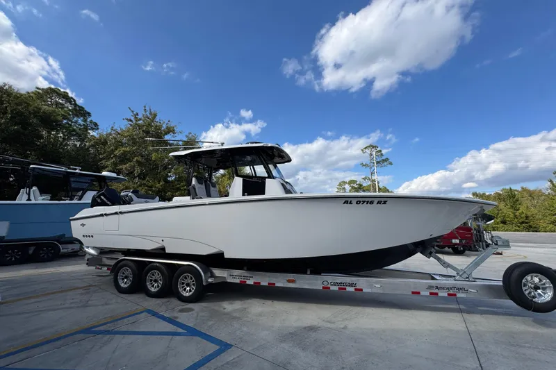  Yacht Photos Pics 2025 Fountain 32 NX boat on trailer under blue sky.