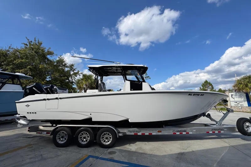  Yacht Photos Pics 2025 Fountain 32 NX boat on trailer under blue sky.