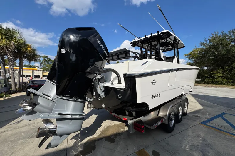 Yacht Photos Pics 2025 Fountain 32 NX boat with dual Mercury outboard engines on a trailer.