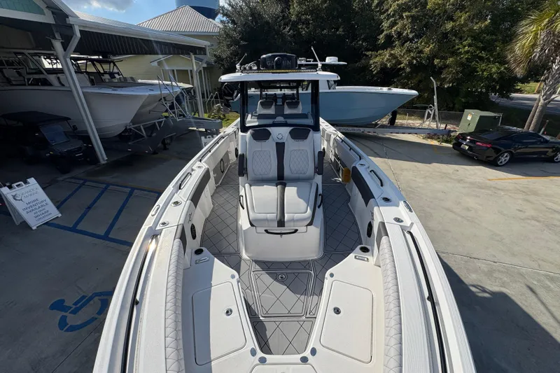  Yacht Photos Pics 2025 Fountain 32 NX boat with sleek design, docked at a marina.
