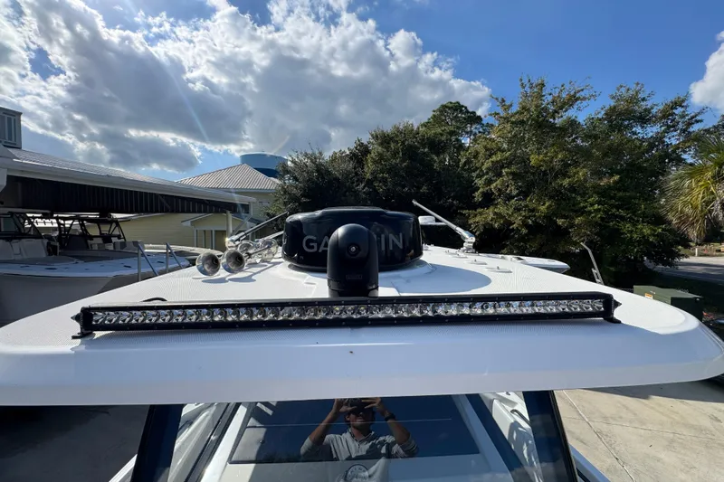  Yacht Photos Pics 2025 Fountain 32 NX boat with radar and light bar under a blue sky.