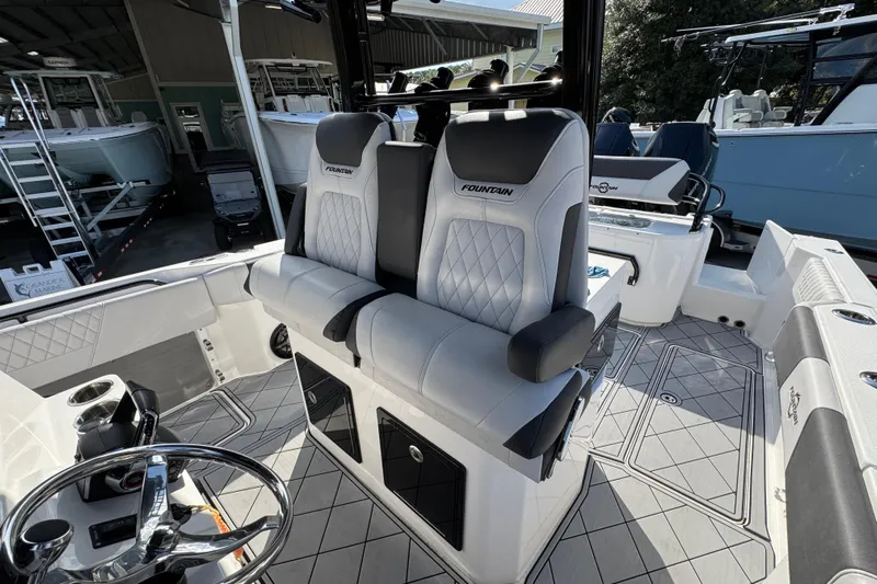 Yacht Photos Pics 2025 Fountain 32 NX boat interior with luxurious seating and modern steering wheel design.