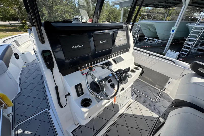  Yacht Photos Pics 2025 Fountain 32 NX boat cockpit with Garmin navigation displays and modern steering controls.