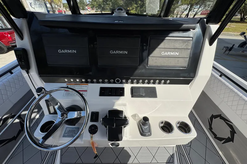  Yacht Photos Pics 2025 Fountain 32 NX boat dashboard with Garmin displays and steering wheel.