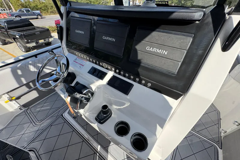  Yacht Photos Pics 2025 Fountain 32 NX boat dashboard with Garmin displays and steering wheel.