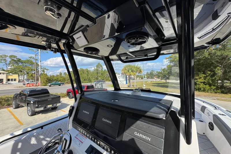  Yacht Photos Pics 2025 Fountain 32 NX boat interior with Garmin displays and sleek black framework.