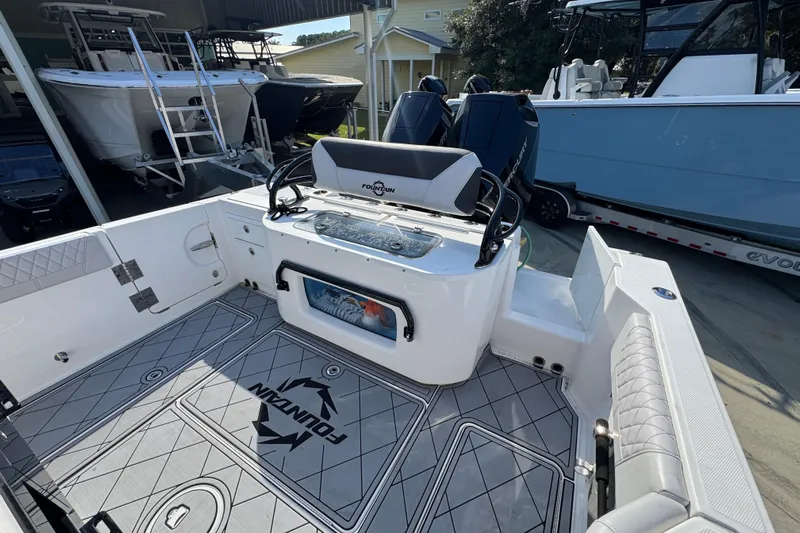  Yacht Photos Pics 2025 Fountain 32 NX boat interior with modern seating and storage, showcasing sleek design.