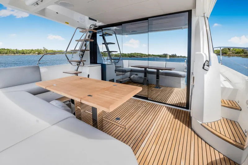 Soiral X Yacht Photos Pics Luxurious 2023 Prestige 520 yacht interior with elegant wood flooring and modern seating.