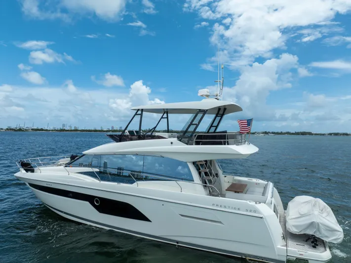 Soiral Yacht Photos Pics 2023 Prestige 520 yacht cruising on a sunny day with clear blue skies.