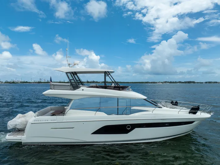 Soiral Yacht Photos Pics Luxury 2023 Prestige 520 yacht cruising on a sunny day with blue skies.