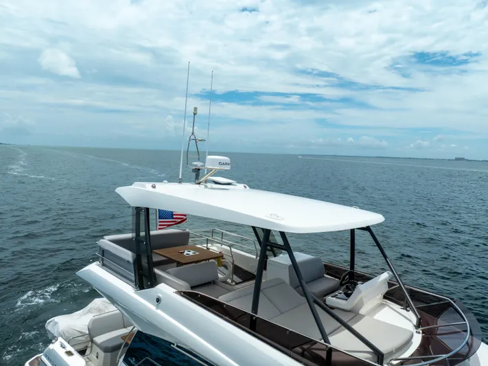 Soiral Yacht Photos Pics Luxury 2023 Prestige 520 yacht cruising on open sea under clear skies.