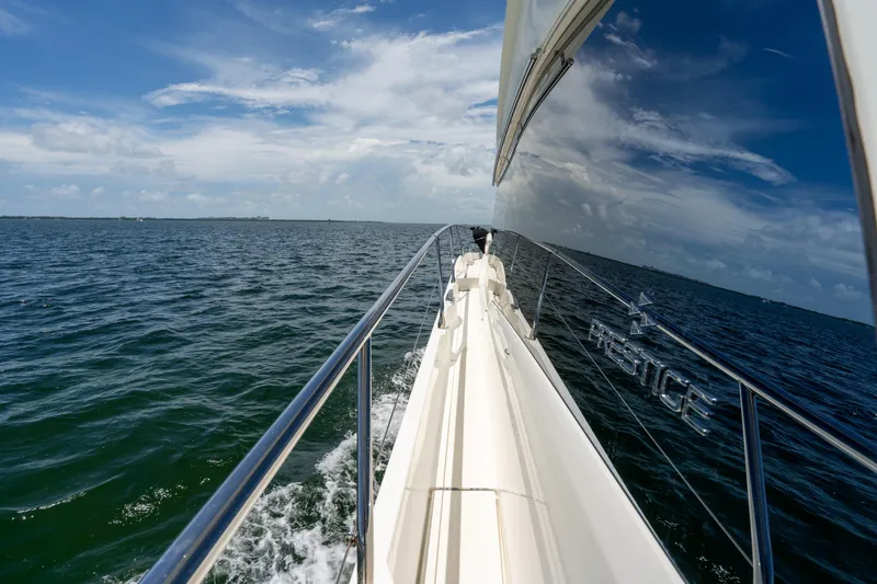 Soiral Yacht Photos Pics 2023 Prestige 520 yacht cruising on open sea under clear blue sky.