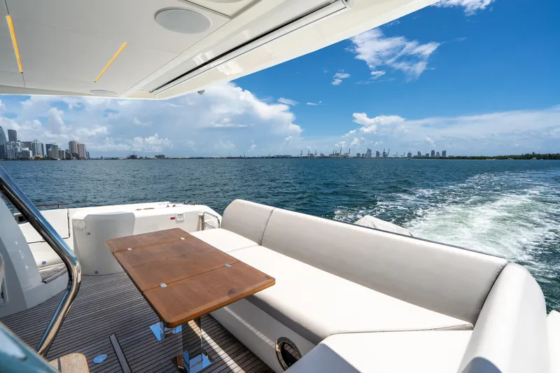 Soiral Yacht Photos Pics Luxury yacht Prestige 520 cruising with city skyline and ocean view, 2023 model.