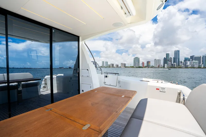 Soiral Yacht Photos Pics Luxury yacht Prestige 520, 2023 model, with city skyline and ocean view.