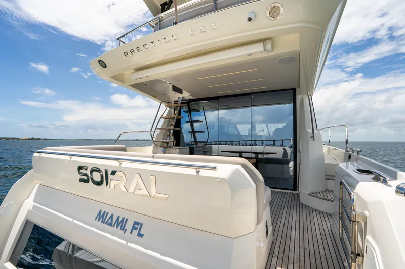 Soiral Yacht Photos Pics Luxury 2023 Prestige 520 yacht docked in Miami, featuring sleek design and spacious deck.