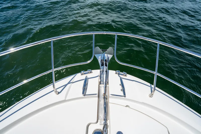 Soiral Yacht Photos Pics Bow of 2023 Prestige 520 yacht with stainless steel railings on open water.