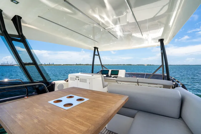 Soiral Yacht Photos Pics Luxurious 2023 Prestige 520 yacht deck with seating and ocean view.