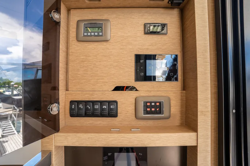 Soiral Yacht Photos Pics Control panel of a 2023 Prestige 520 yacht with various switches and displays.