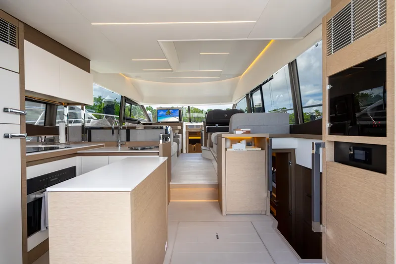 Soiral Yacht Photos Pics Luxurious interior of 2023 Prestige 520 yacht featuring modern kitchen and spacious seating area.